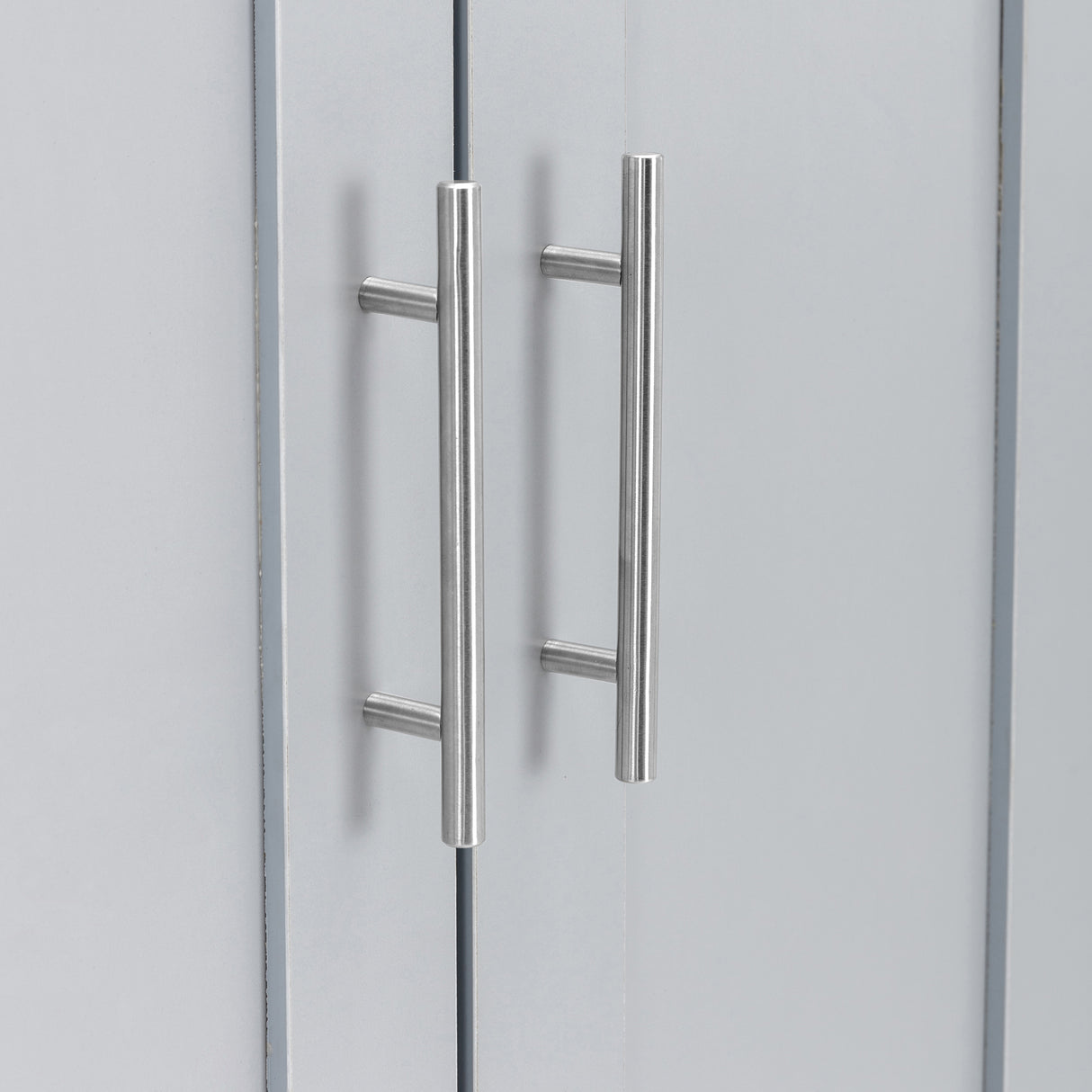 lose-up of stainless steel handles on a grey wardrobe door