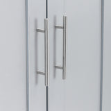 lose-up of stainless steel handles on a grey wardrobe door