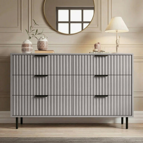 [Grey] Front view of 6 drawer wide chest with vertical panel detailing and black metal handles