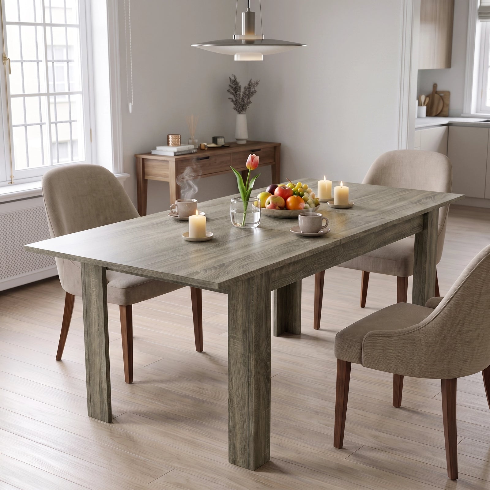 [Wooden Grey] Closed grey wood-effect dining table styled with fruit, flowers and candles; beige chairs stand by its legs.