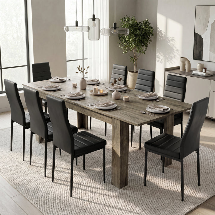 [Wooden Grey] Extended grey wood-effect dining table for 6-8 at dinner; eight black chairs surround its thick square legs.