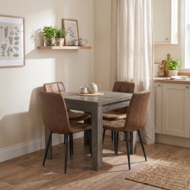 [Grey Wood] Closed flip-top dining table with four brown chairs and tea set in a bright open-plan kitchen diner.