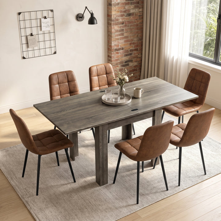 [Grey Wood] Extended flip-top dining table with six brown chairs, flower vase, two glasses and mug in a bright dining room