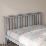 Grey wooden double bed, offering a stylish and sturdy design for a comfortable sleep experience.