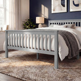 Grey wooden bed frame with vertical slat detailing on both the headboard and footboard, placed in a bedroom