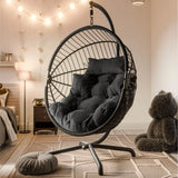 [Black] Black wicker hanging egg chair with black cushions in bedroom with string lights and teddy bear