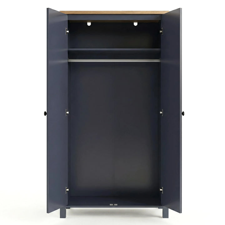 [Blue] Open empty Haven wardrobe, blue body with oak top, internal shelf above clothes hanging rail