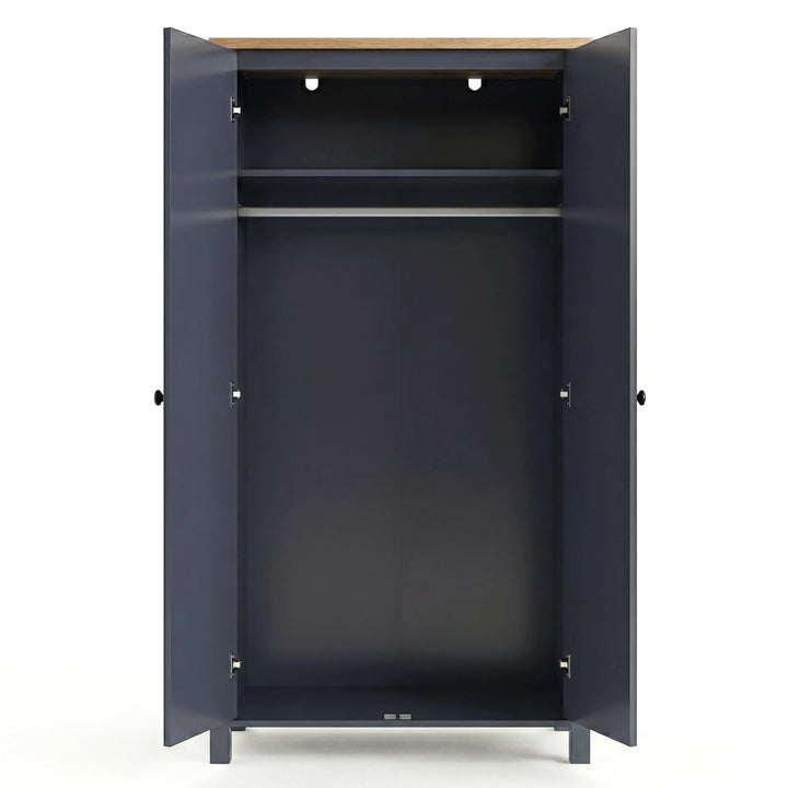 [Blue] Open empty Haven wardrobe, blue body with oak top, internal shelf above clothes hanging rail