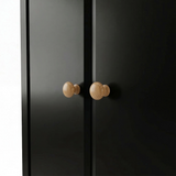[Black] Haven wardrobe handle detail showing pair of turned oak knobs set on flush door fronts