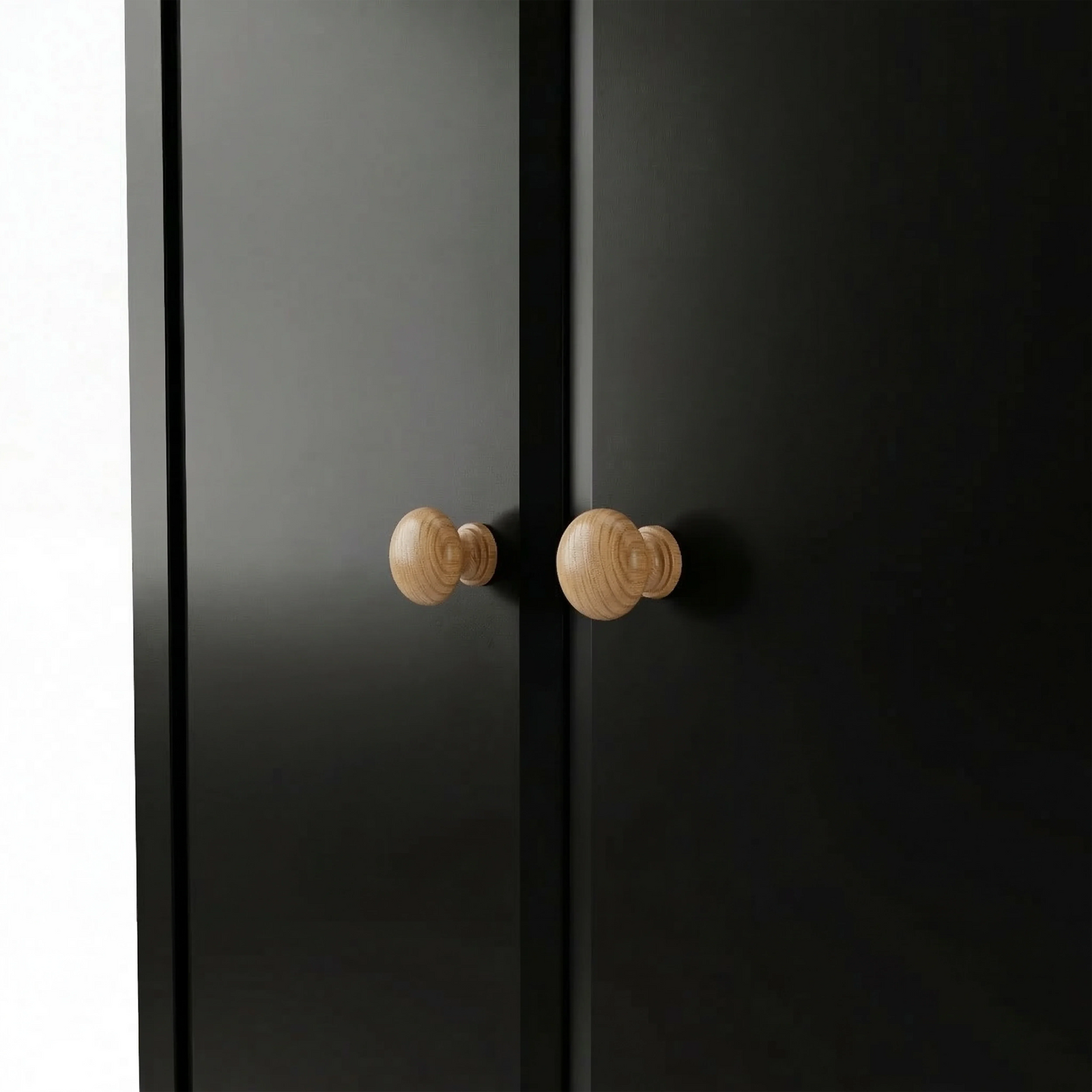 [Black] Haven wardrobe handle detail showing pair of turned oak knobs set on flush door fronts