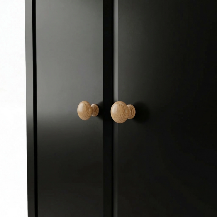 [Black] Haven wardrobe handle detail showing pair of turned oak knobs set on flush door fronts