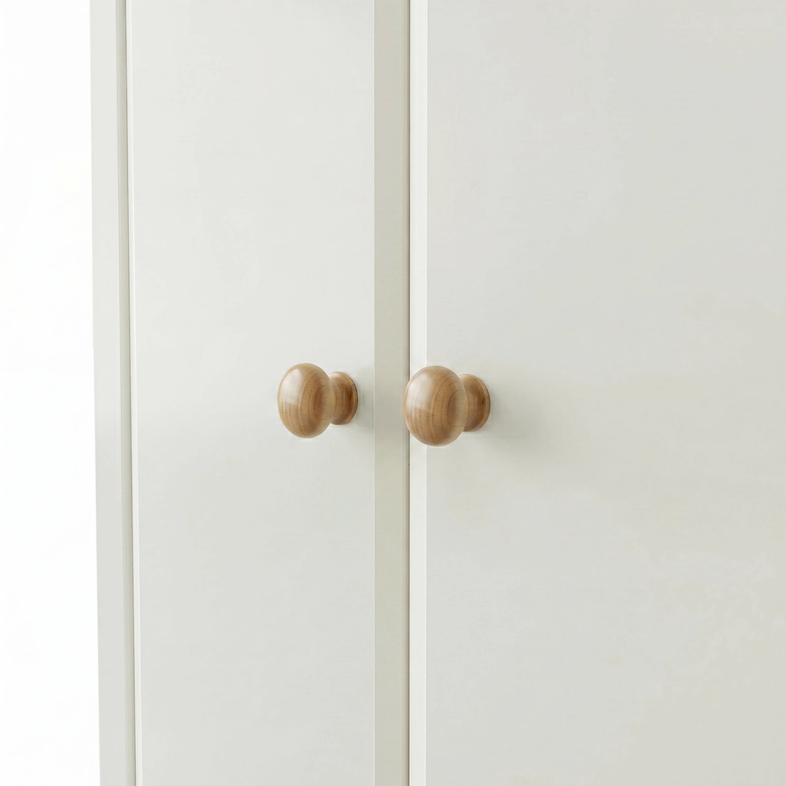 [White] Haven 3-door wardrobe close-up of two round solid oak wooden knob handles on painted doors