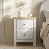 [White] Bedside Haven bedroom furniture set shown beside bed with lamp on the oak veneer top