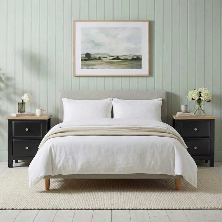 [Black] Haven 2-drawer bedside table styled centrally in a bedroom with decorative objects on oak veneer top