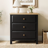 [Black] Haven 3-drawer chest front view in a neutral styled room with floral arrangement on oak veneer top