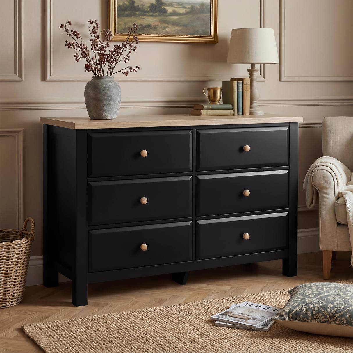 [Black] Haven chest of drawers in a bedroom setting with artwork above and dried floral arrangement on oak top