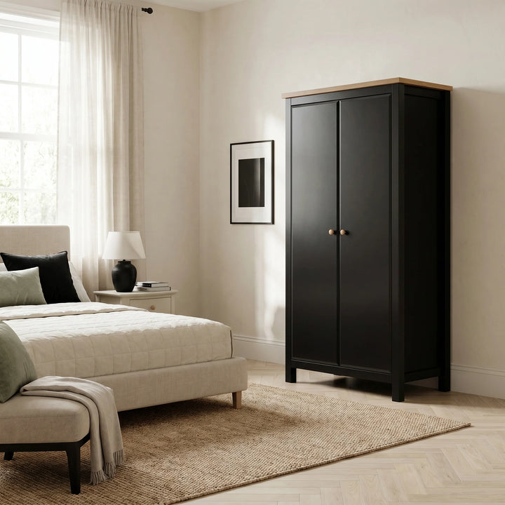 [Black] Haven Black 2 Door Double Wardrobe with Shelves and Hanging Rail closed view in a bright bedroom setting.