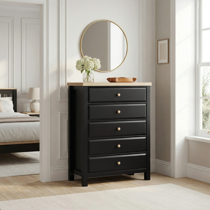[Black] Haven 5-drawer tall chest in a bedroom setting with round mirror and soft furnishings in the background