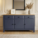 [Blue] Haven 3-door sideboard front view in a styled room with decorative objects arranged on oak veneer top
