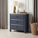 [Blue] Haven 3-drawer chest in panelled room with lamp, vase and books on oak top and woven basket on floor right