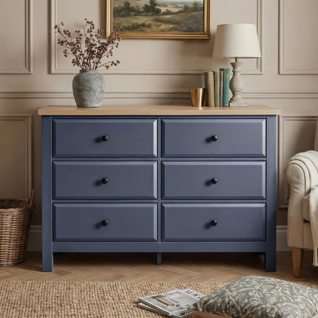 [Blue] Haven 6-drawer chest front view from low angle in a warm room with lamp and floral arrangement on top