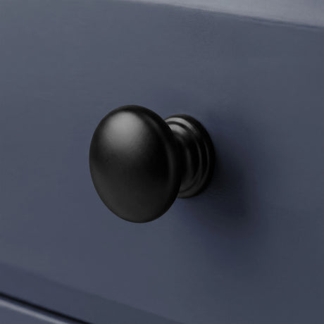 [Blue] Haven chest of drawers close-up of a round solid black wooden knob handle on a painted drawer front
