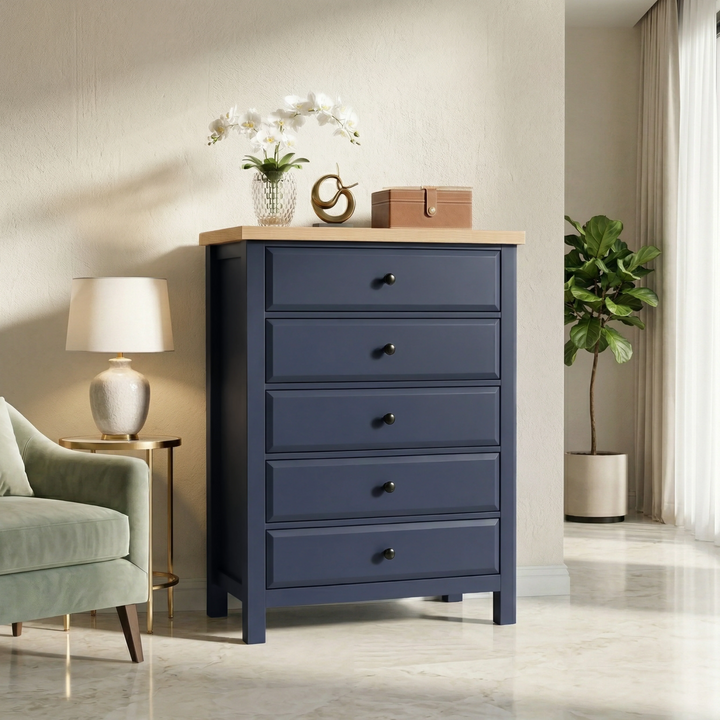 [Blue] Haven 5-drawer chest front lifestyle on marble floor, flanked by table lamp and potted plant in cream room