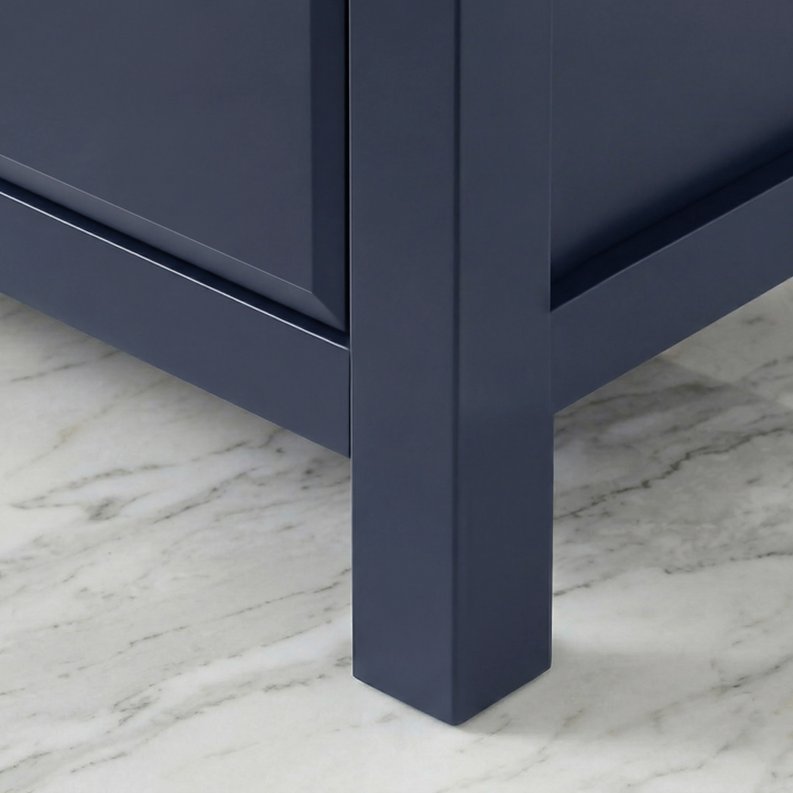 [Blue] Haven chest corner foot view, blue painted tapered leg meeting marble flooring with chamfered base edge