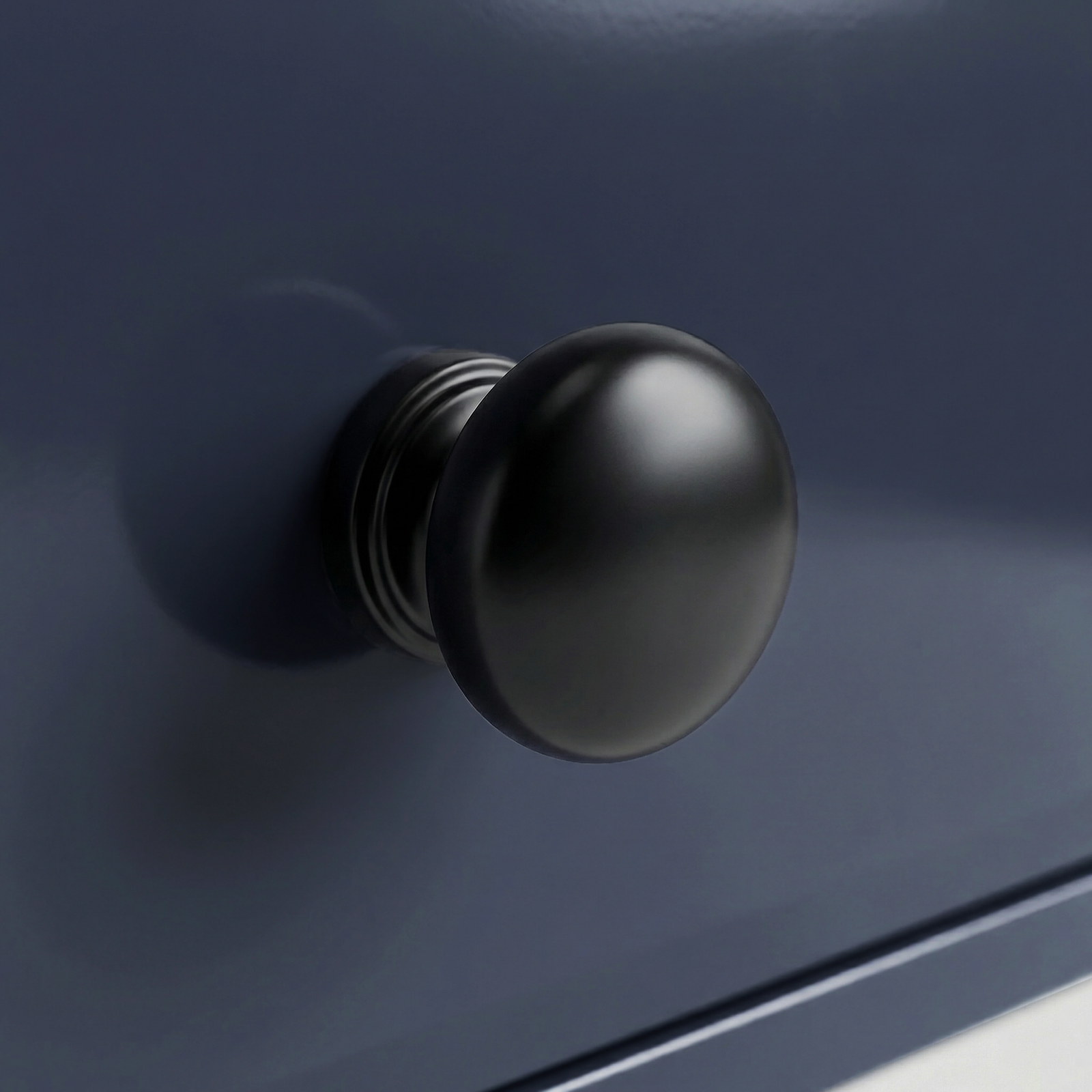 [Blue] Haven 5-drawer chest detail showing one black metal knob with turned ringed neck against blue drawer face