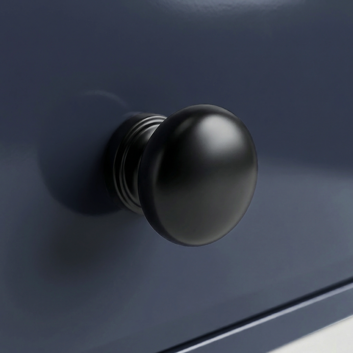 [Blue] Haven 5-drawer chest detail showing one black metal knob with turned ringed neck against blue drawer face