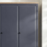 [Blue] Haven wardrobe upper section close-up showing oak veneer top edge and round knob handles on panel doors