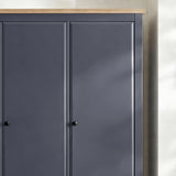 [Blue] Haven wardrobe upper section close-up showing oak veneer top edge and round knob handles on panel doors
