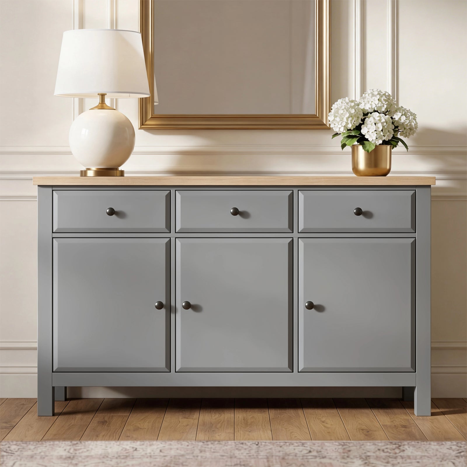 [Grey] Haven 3-door sideboard front view in a styled room with decorative objects arranged on oak veneer top