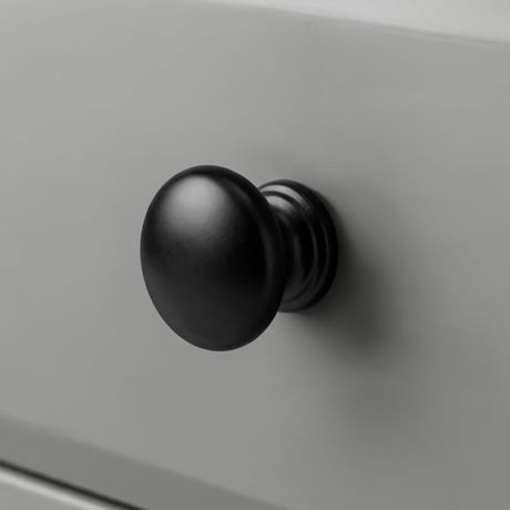 [Grey] Haven 3-drawer chest close-up of a single round solid black wooden knob handle on a painted drawer front