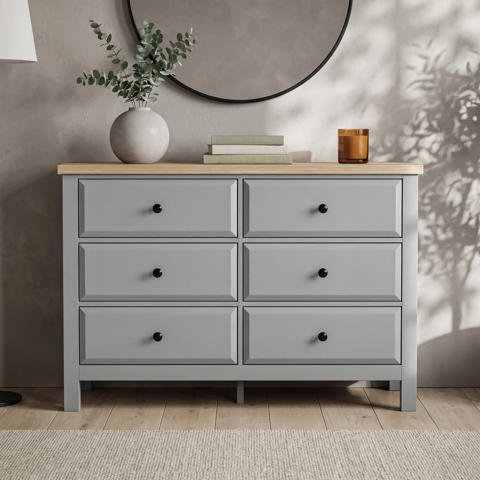 [Grey] Haven 6-drawer chest front view in a styled room with vase, candle and dried botanicals on oak top