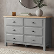 [Grey] Haven chest of drawers front view from low angle with decorative vase and candle on oak veneer top