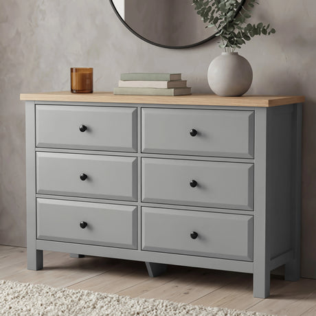[Grey] Haven chest of drawers front view from low angle with decorative vase and candle on oak veneer top