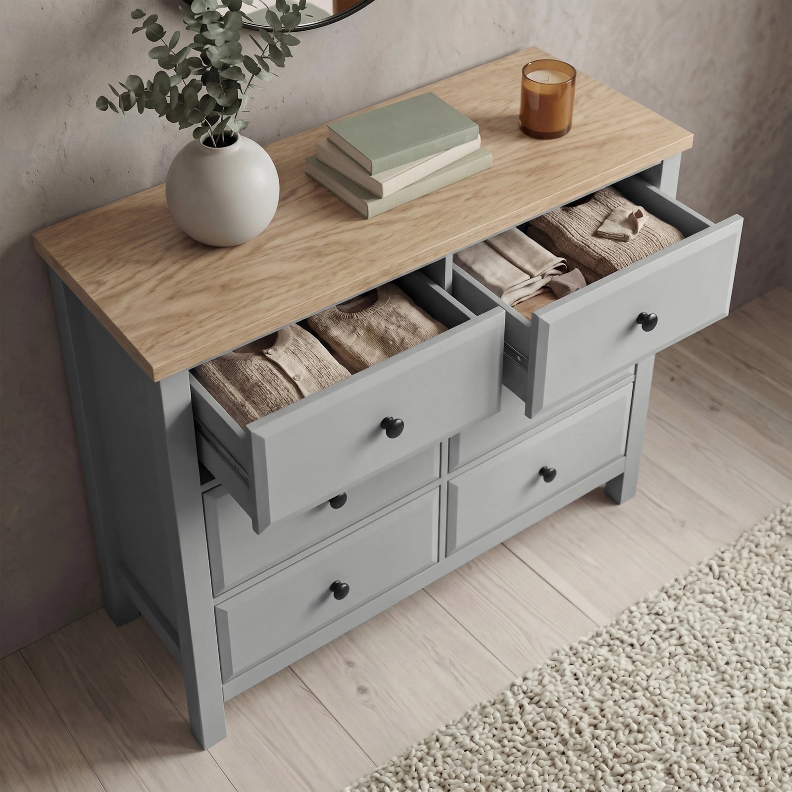 [Grey] Haven chest of drawers with multiple drawers open showing interior storage depth and oak veneer top