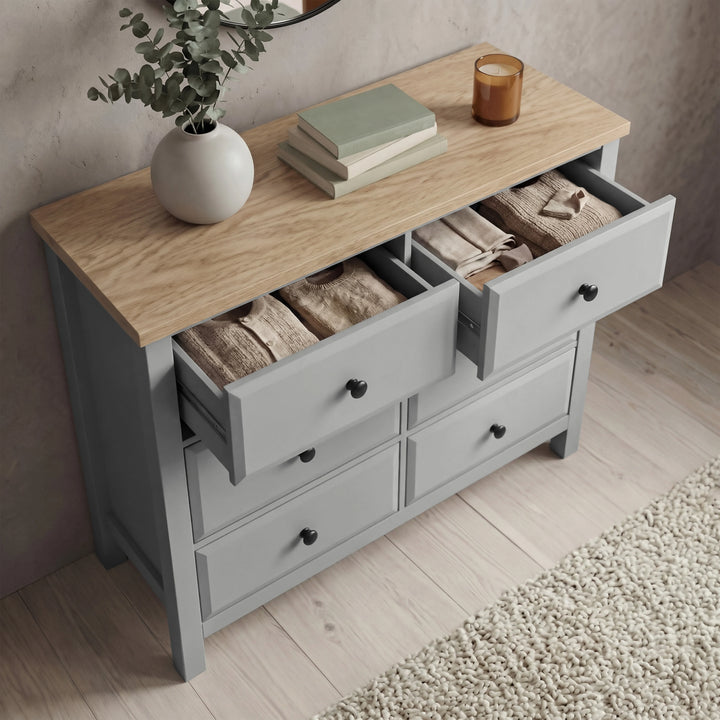 [Grey] Haven chest of drawers with multiple drawers open showing interior storage depth and oak veneer top