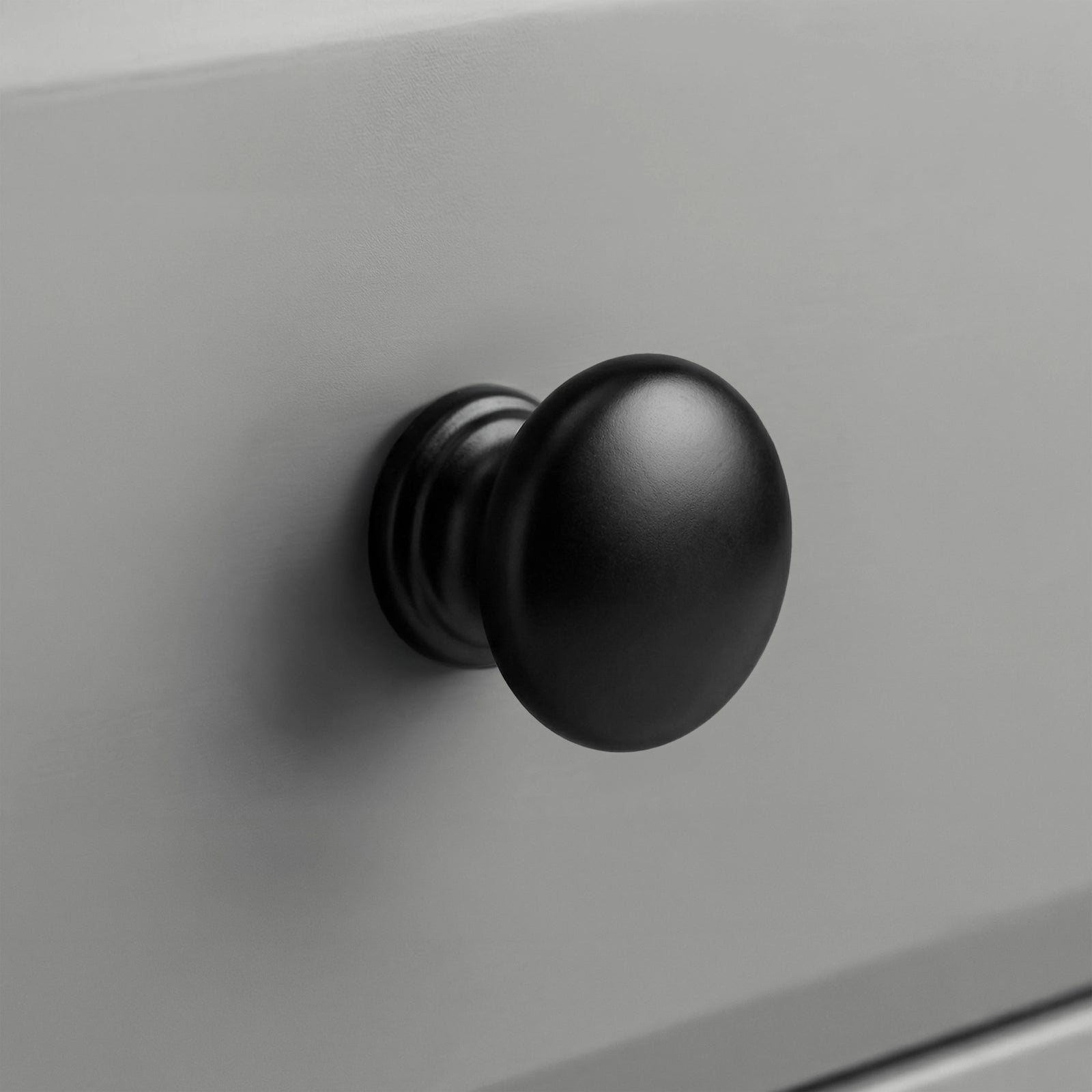 [Grey] Haven 6-drawer chest round black knob handle close-up with stepped collar on grey painted drawer front