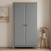 [Grey] Haven Grey 2 Door Double Wardrobe with Shelves and Hanging Rail closed straight-on look next to a wooden stool.