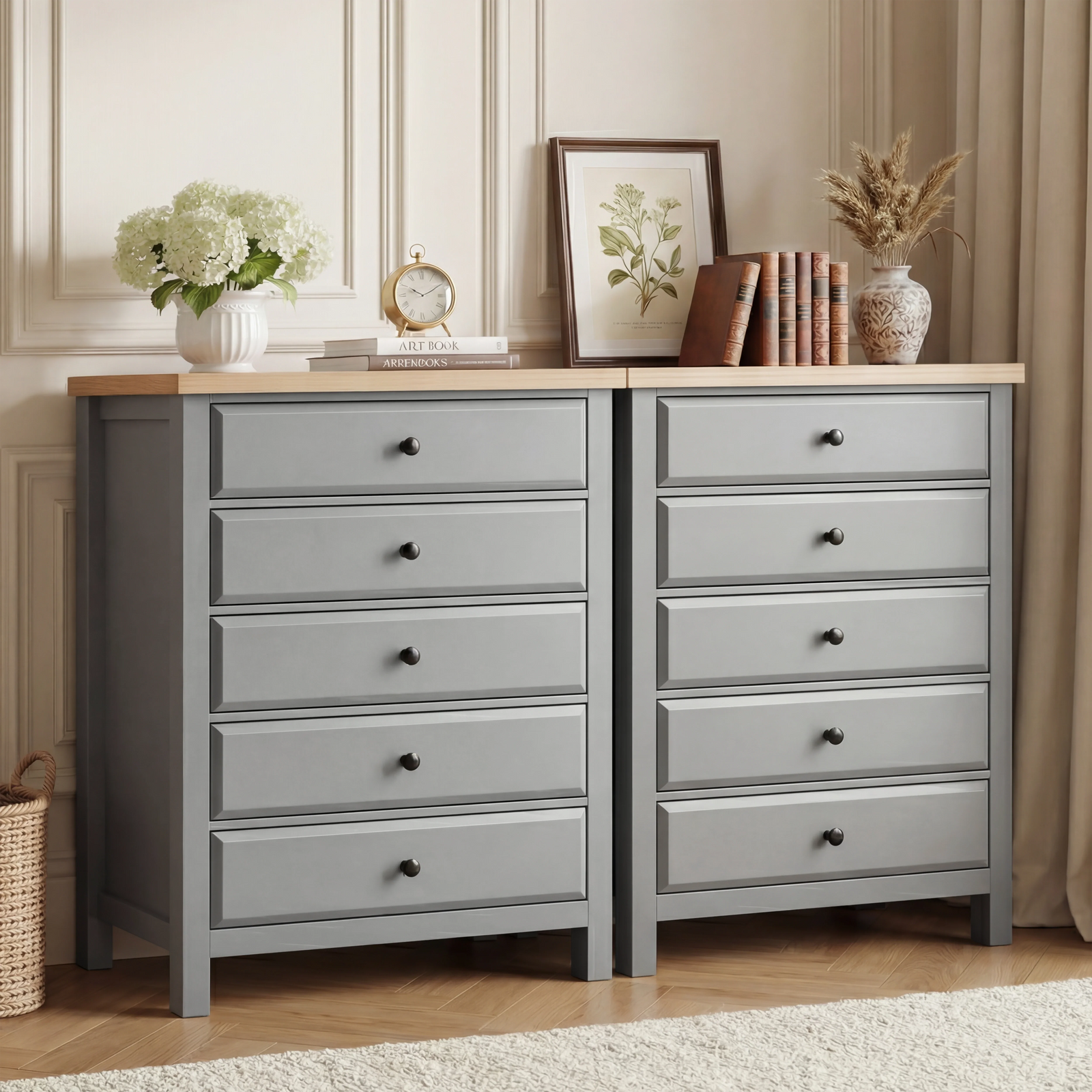 [Grey] Two Haven tall chest of drawers placed side by side in a bedroom with framed art and stems on oak tops