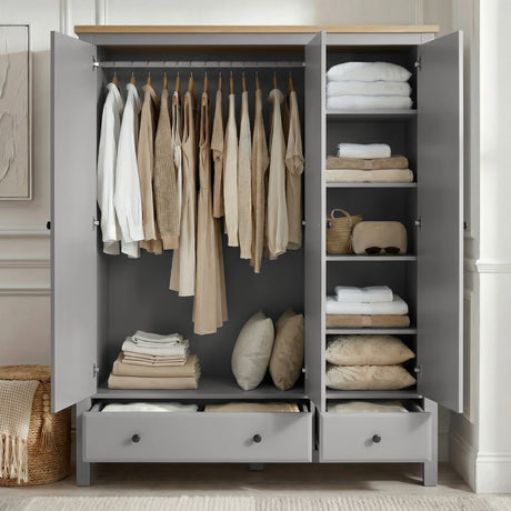 [Grey] Haven 3-door wardrobe fully open in a bedroom showing hanging rail with clothes, shelves and folded items