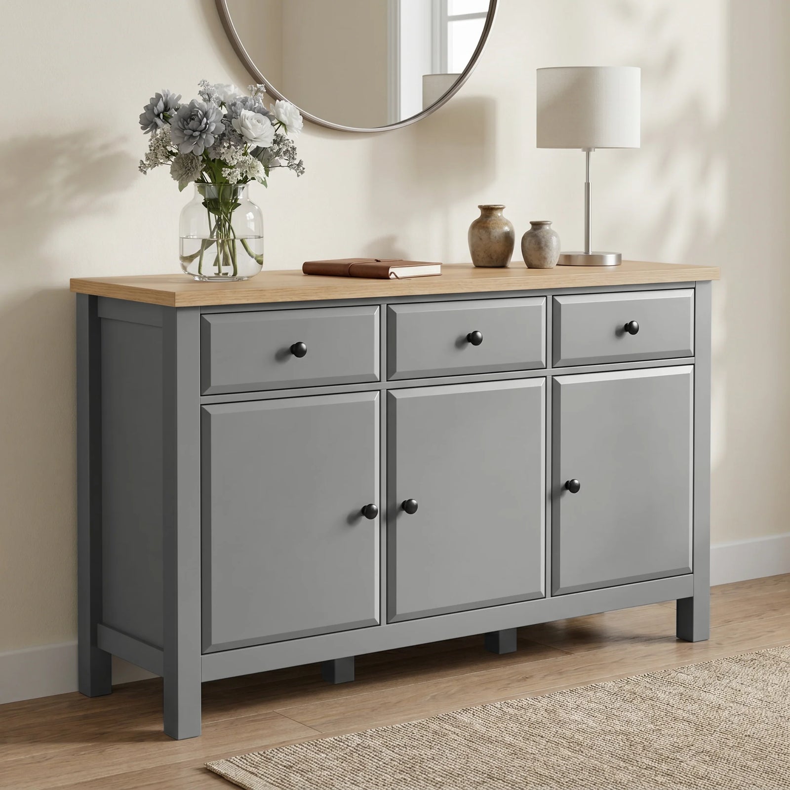 [Grey] Haven Large Black Sideboard with Drawers & Oak Top shown from a low angle in a living room.