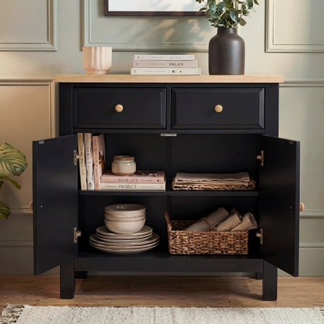 [Black] Haven sideboard with both cabinet doors open, central divider and one internal shelf with books