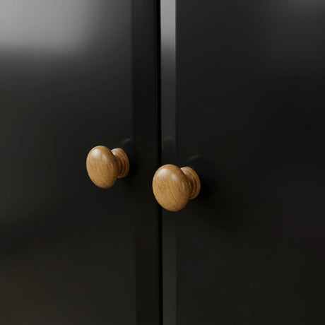 [Black] Pair of round oak knobs on the Haven 2 door wardrobe where the two black doors meet.