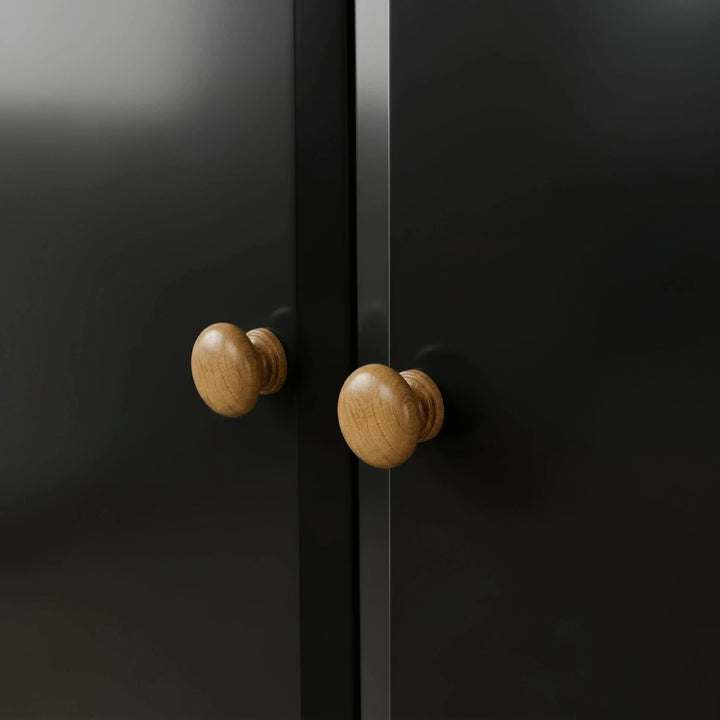 [Black] Pair of round oak knobs on the Haven 2 door wardrobe where the two black doors meet.