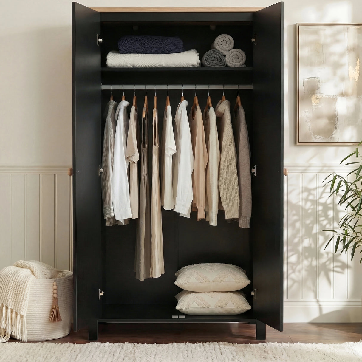 [Black] Haven wardrobe doors open, black interior with rail of shirts and folded linens on shelf above.