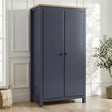 [Blue] Haven wardrobe angled in a bright room, blue painted 2 door frame with warm oak top and round black knobs