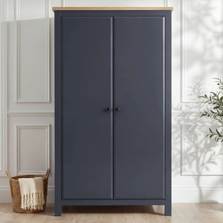 [Blue] Haven wardrobe shown front-on, blue painted doors, warm oak top and raised tapered leg stance